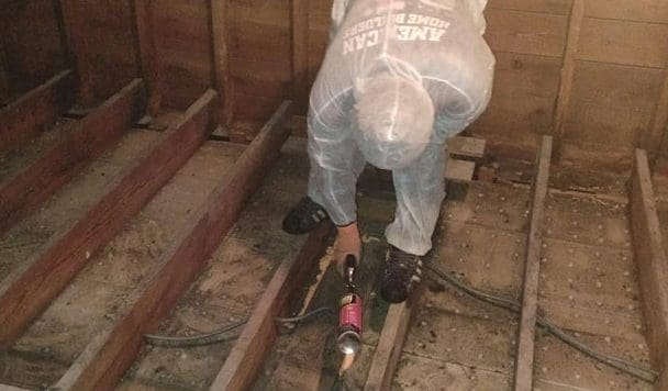 Home Technician installing floor insulation